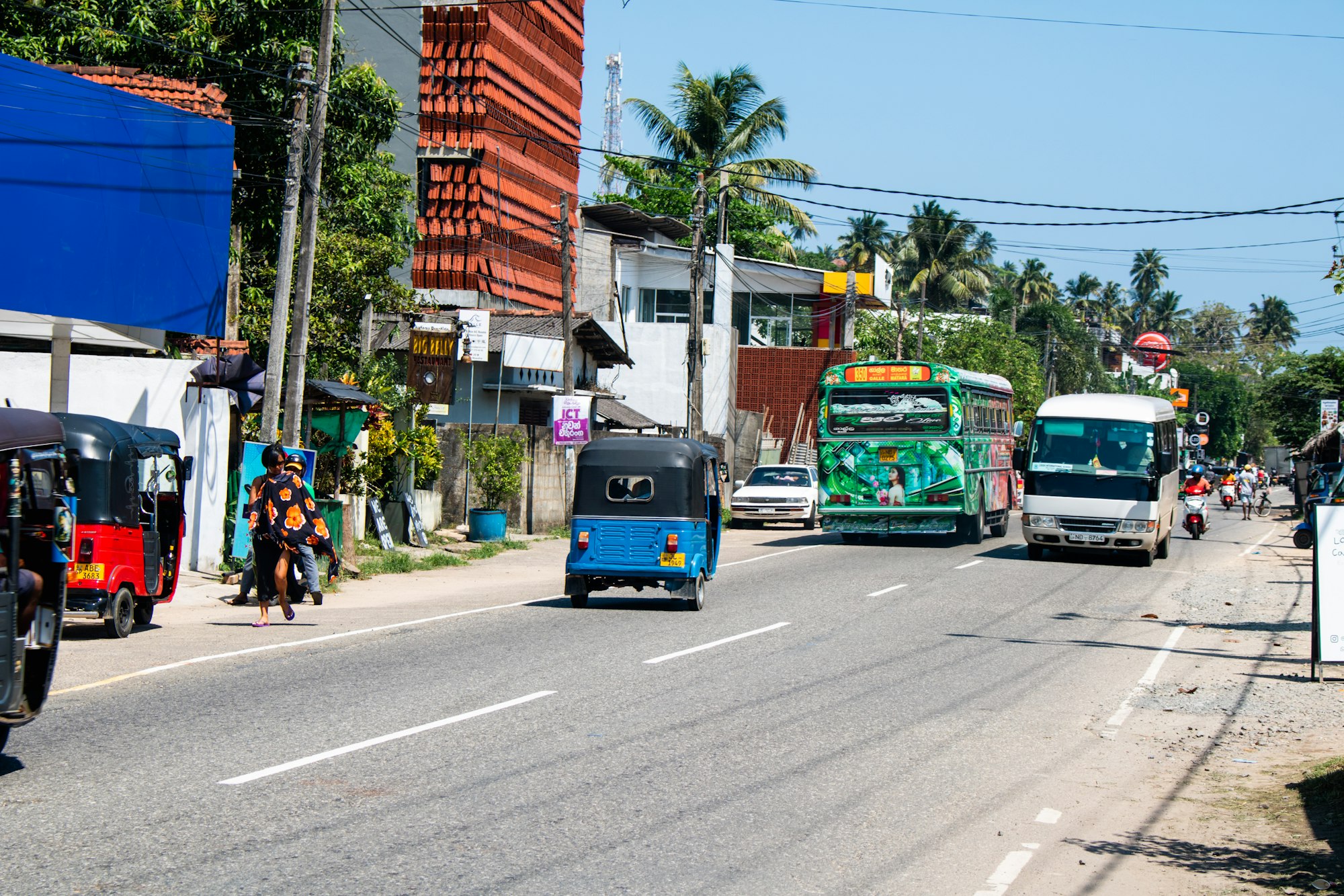 Tuk-tuks and buses on a busy street in Trincomalee