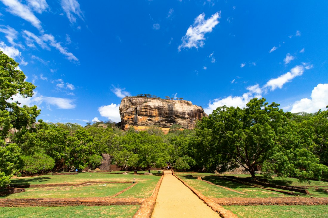 The Sigiriya rock fortress rising above flat green jungle